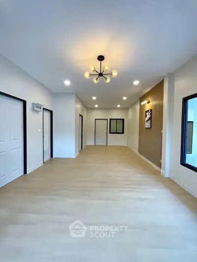 Spacious modern living room with elegant lighting and large windows