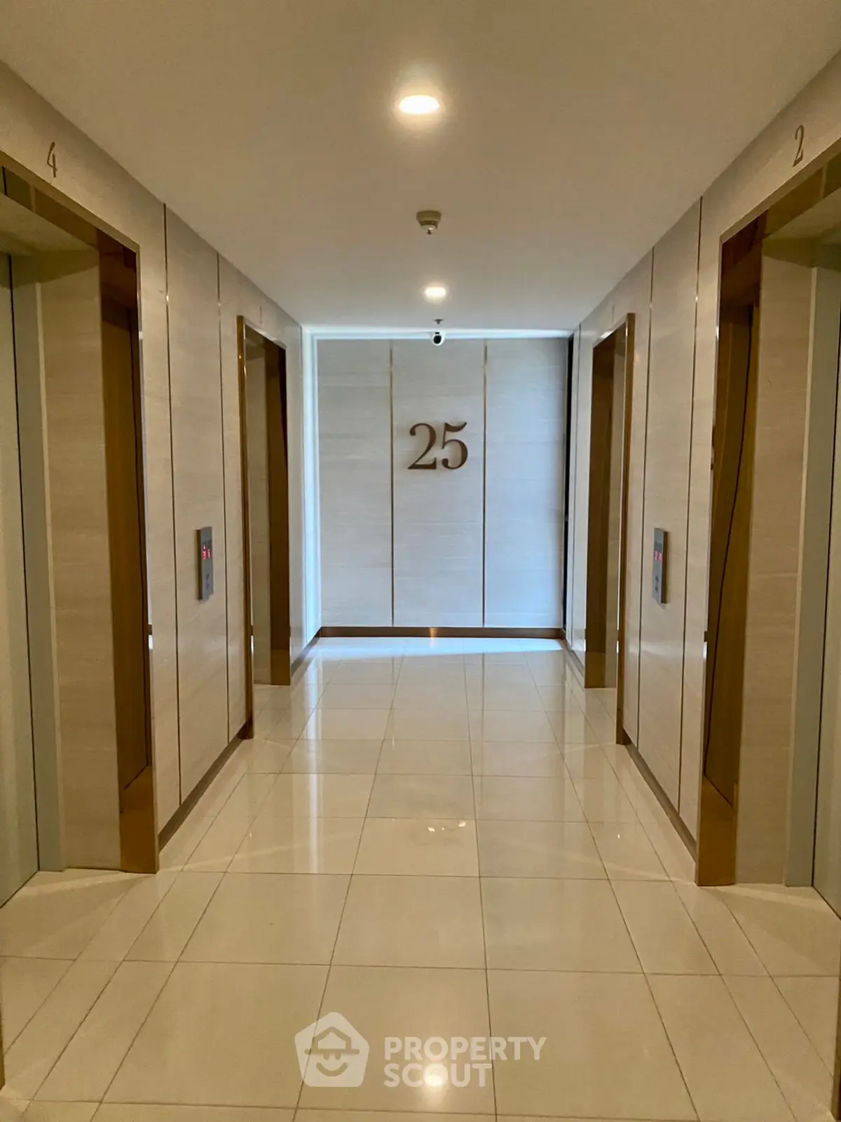 Elegant modern elevator lobby on the 25th floor with sleek design and polished tiles.