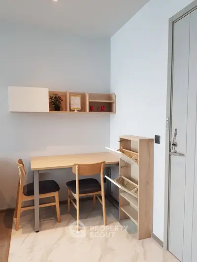 Modern study area with wooden desk and chairs, ideal for home office setup.