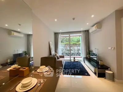 Modern living room with elegant decor and large window opening to a lush garden view.