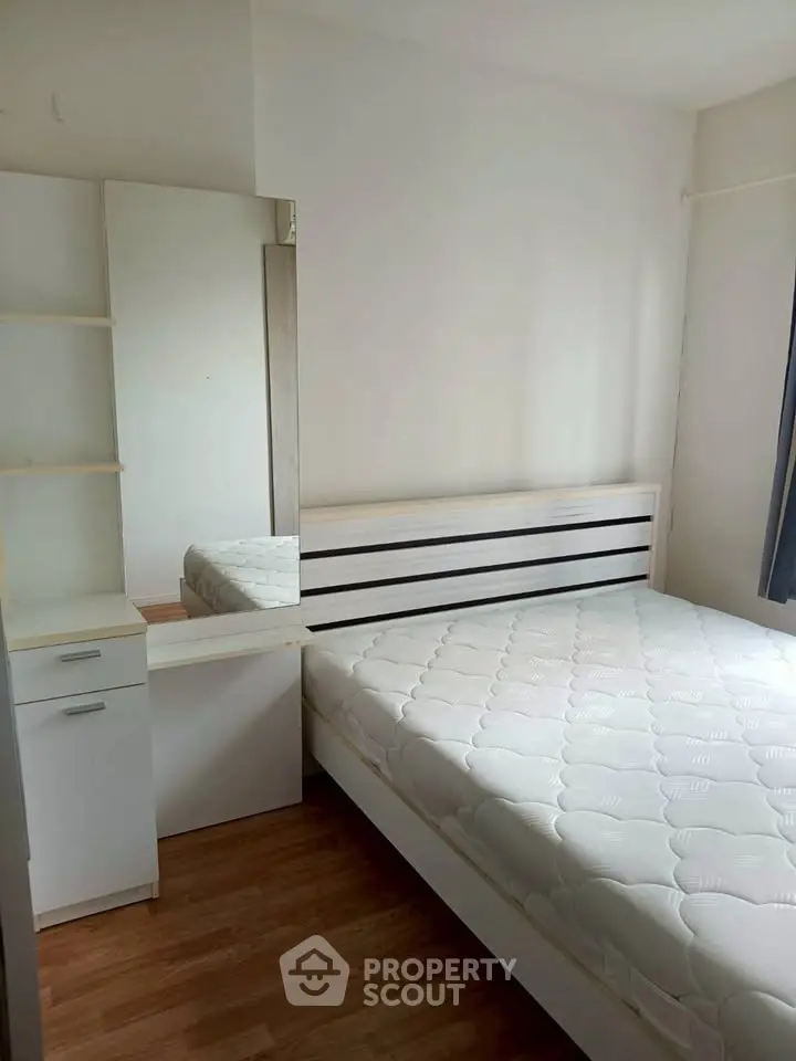 Cozy bedroom with modern furniture and ample natural light, perfect for relaxation and comfort.