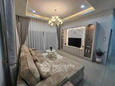 Luxurious living room with elegant chandelier and plush sectional sofa