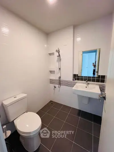 Modern bathroom with sleek white tiles and contemporary fixtures