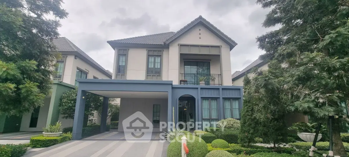 Elegant two-story house with manicured garden and spacious driveway