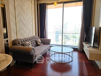 Luxurious living room with elegant sofa and stunning city view from large window.