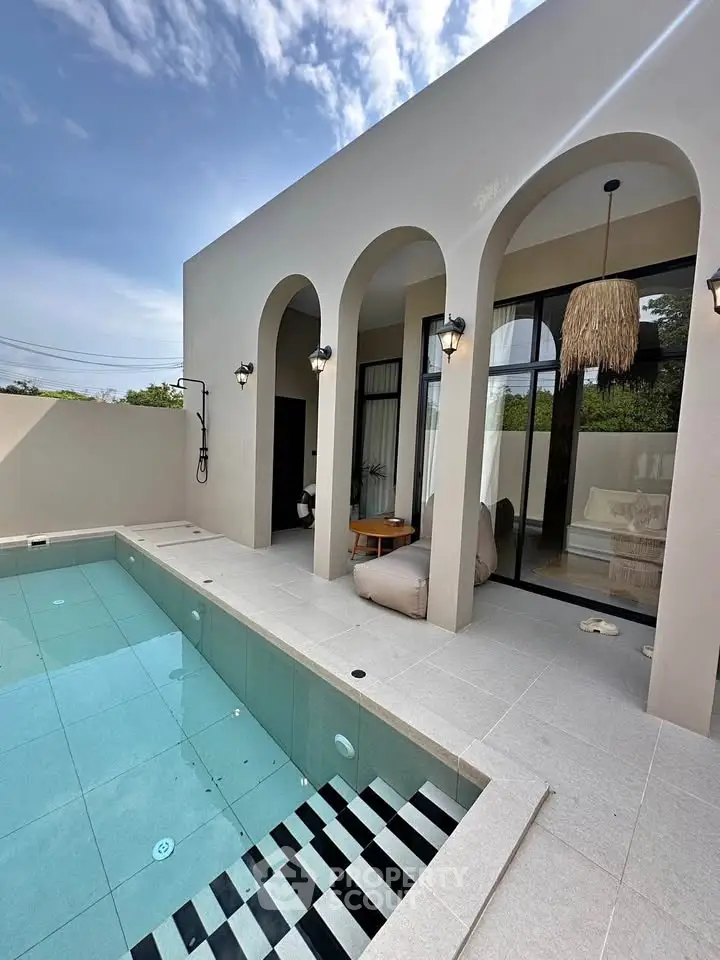 Luxurious modern villa with private pool and elegant arches, perfect for relaxation and entertaining.