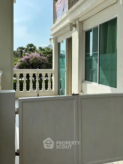 Charming balcony with lush garden view in modern apartment