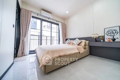 Modern bedroom with large windows and stylish decor