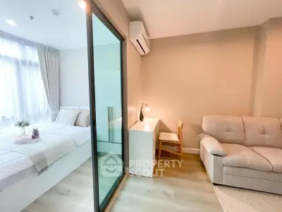 Modern studio apartment with cozy bedroom and living area, featuring stylish decor and natural light.
