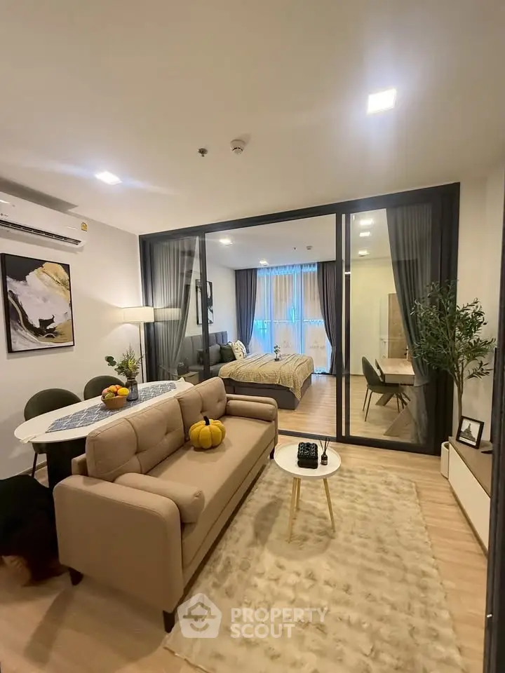 Modern open-plan living room with stylish decor and cozy ambiance in a contemporary apartment.