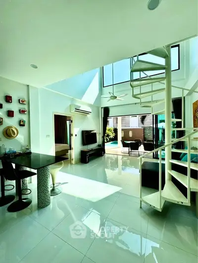 Stunning modern living room with spiral staircase and abundant natural light