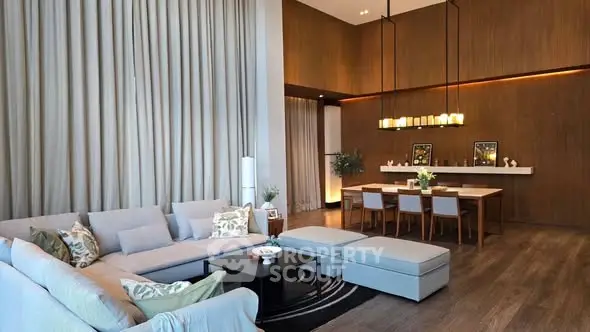 Luxurious modern living room with high ceilings and elegant dining area