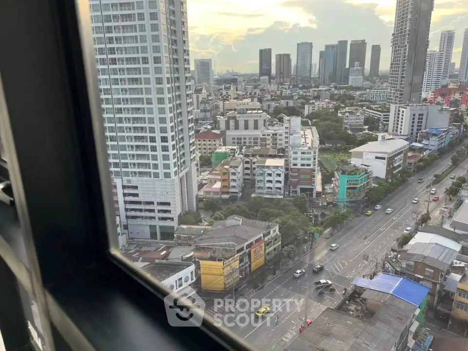 Stunning cityscape view from a high-rise window showcasing urban skyline and bustling streets.