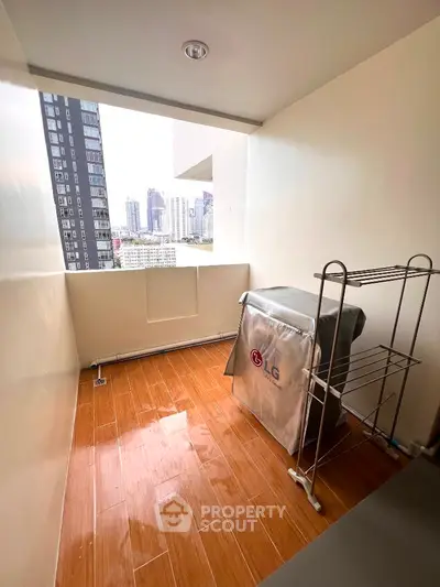 Cozy balcony with city view and laundry area in modern apartment