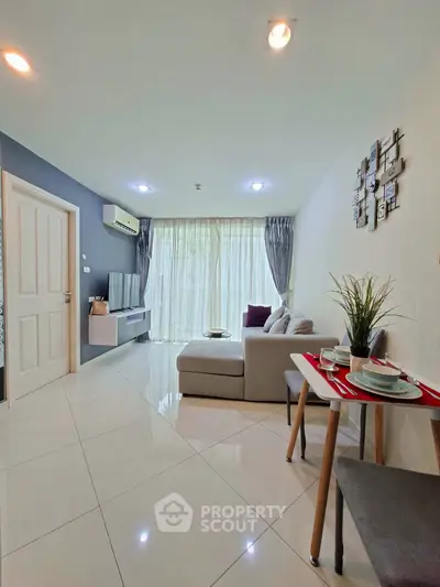 Modern living room with sleek design, featuring a cozy sofa, stylish decor, and ample natural light.