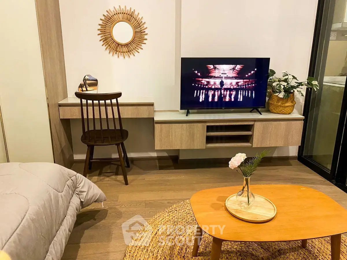 Cozy living room with modern decor, TV, and stylish furniture in a contemporary apartment.