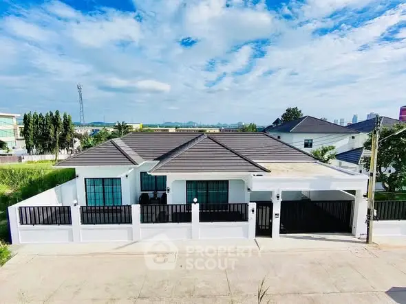 Modern single-story house with sleek design and spacious driveway