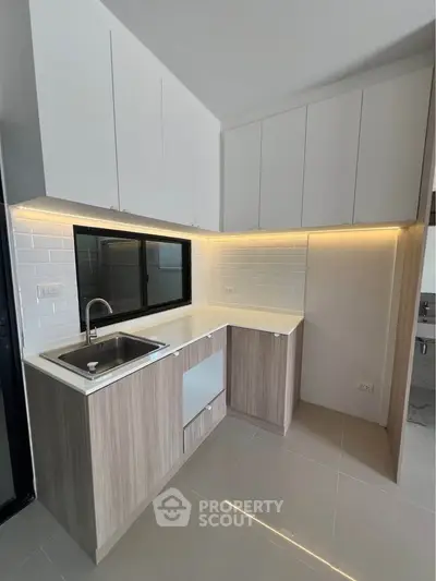 Modern kitchen with sleek cabinetry and under-cabinet lighting
