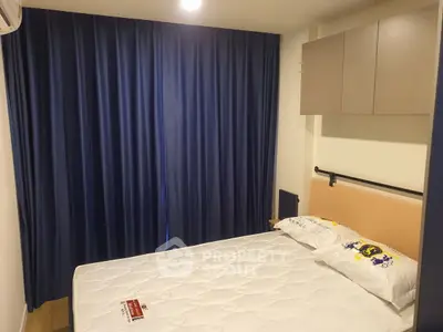 Cozy bedroom with blue curtains and modern storage cabinets, perfect for restful nights.