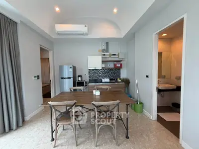 Modern open-layout kitchen and dining area with stylish furniture and appliances