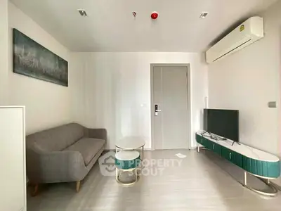 Modern living room with sleek furniture and wall-mounted air conditioner