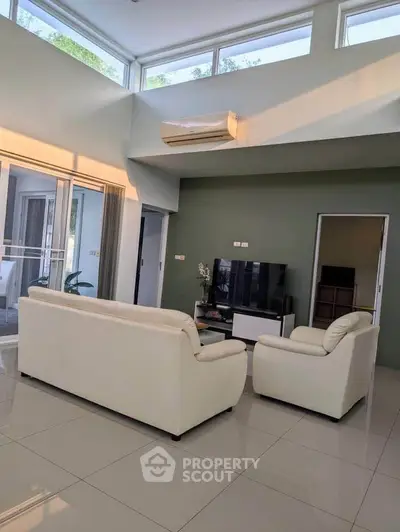 Spacious modern living room with high ceilings and natural light