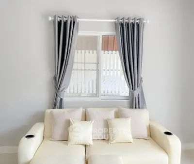 Modern living room with elegant sofa and stylish curtains, perfect for cozy relaxation.