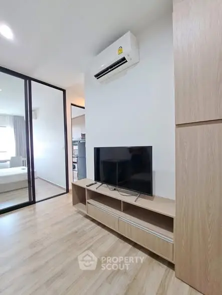 Modern living room with sleek TV stand and air conditioning in stylish apartment.
