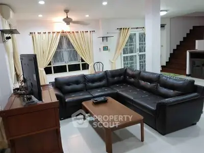 Spacious living room with leather sectional sofa and modern decor