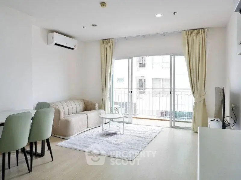 Bright and airy living room with modern furniture and balcony access