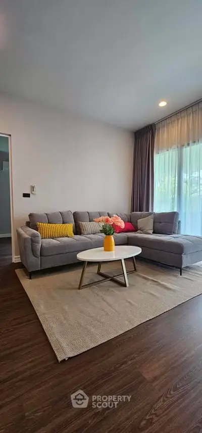 Spacious living room with modern gray sofa and stylish decor
