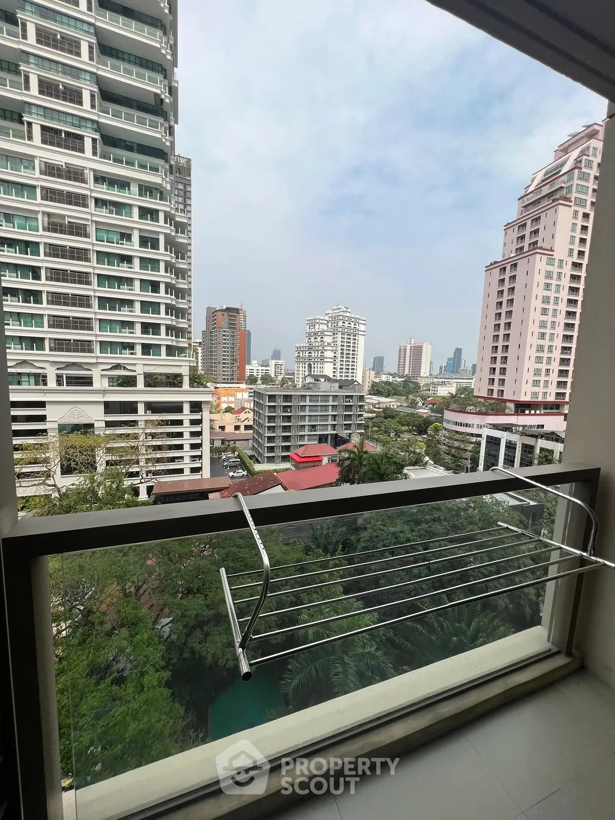 Stunning cityscape view from a modern balcony in a high-rise building.