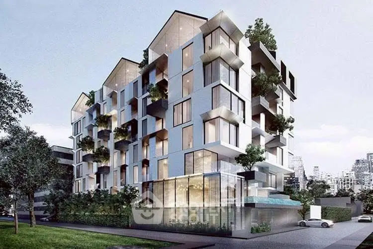 Modern architectural building with lush greenery and large windows in urban setting.