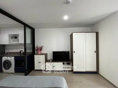 Modern studio apartment with sleek kitchen and in-unit laundry