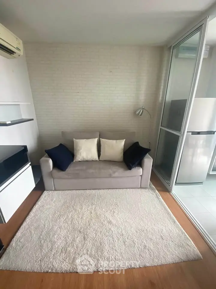 Modern living room with cozy sofa and stylish decor in a bright apartment.