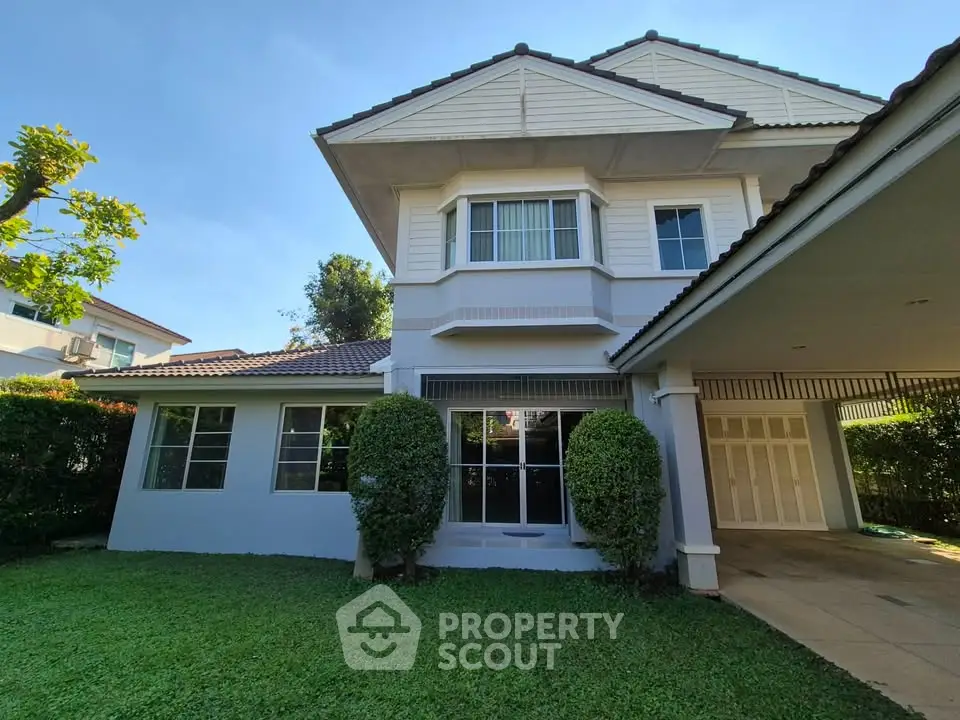 Charming two-story house with lush garden and spacious driveway