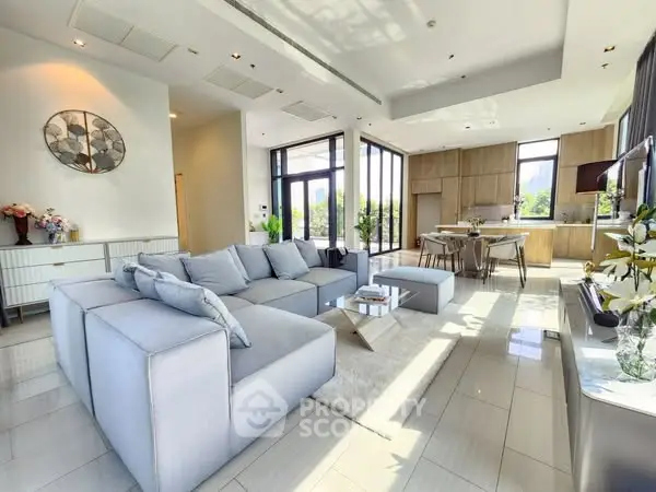 Spacious modern living room with open kitchen and large windows