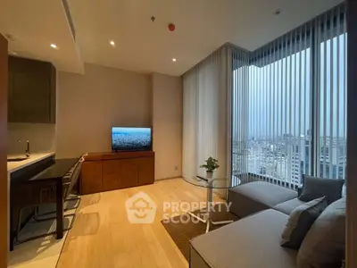 Modern living room with city view, featuring sleek furniture and floor-to-ceiling windows.