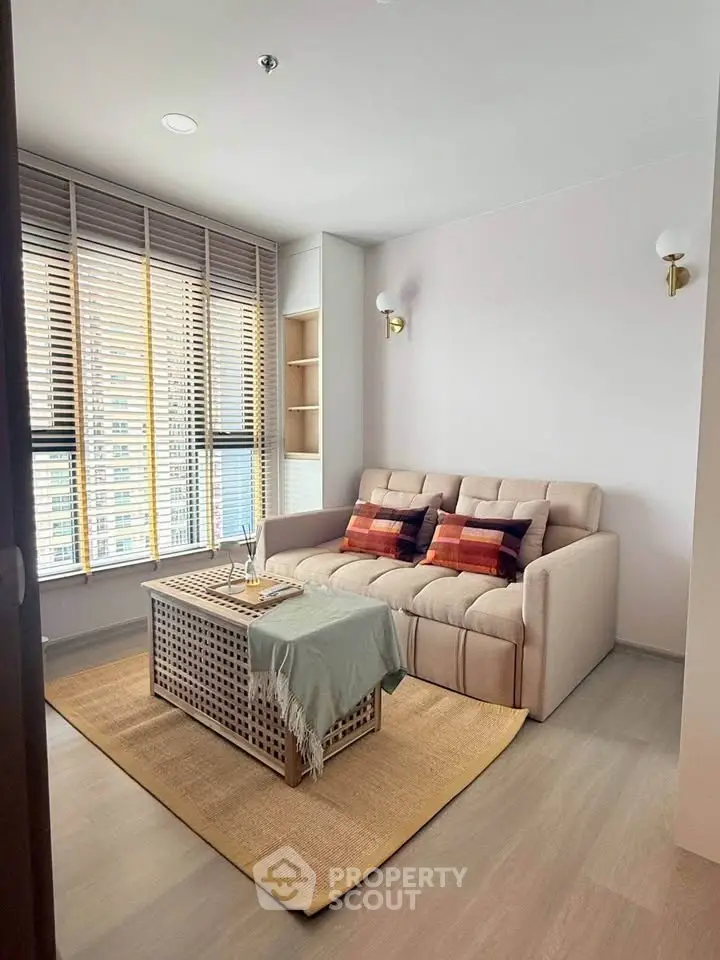 Cozy living room with modern sofa and stylish decor in a bright apartment.