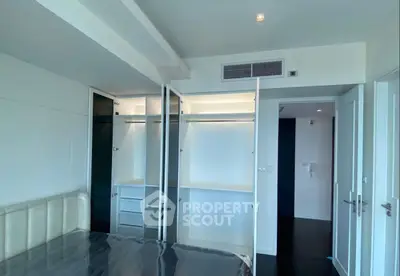 Spacious bedroom with modern walk-in closet and sleek design