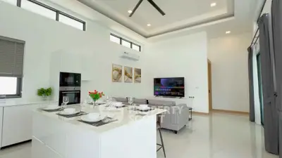 Modern open-plan living room with sleek kitchen island and stylish decor