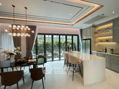 Luxurious modern kitchen with island and elegant lighting in open layout