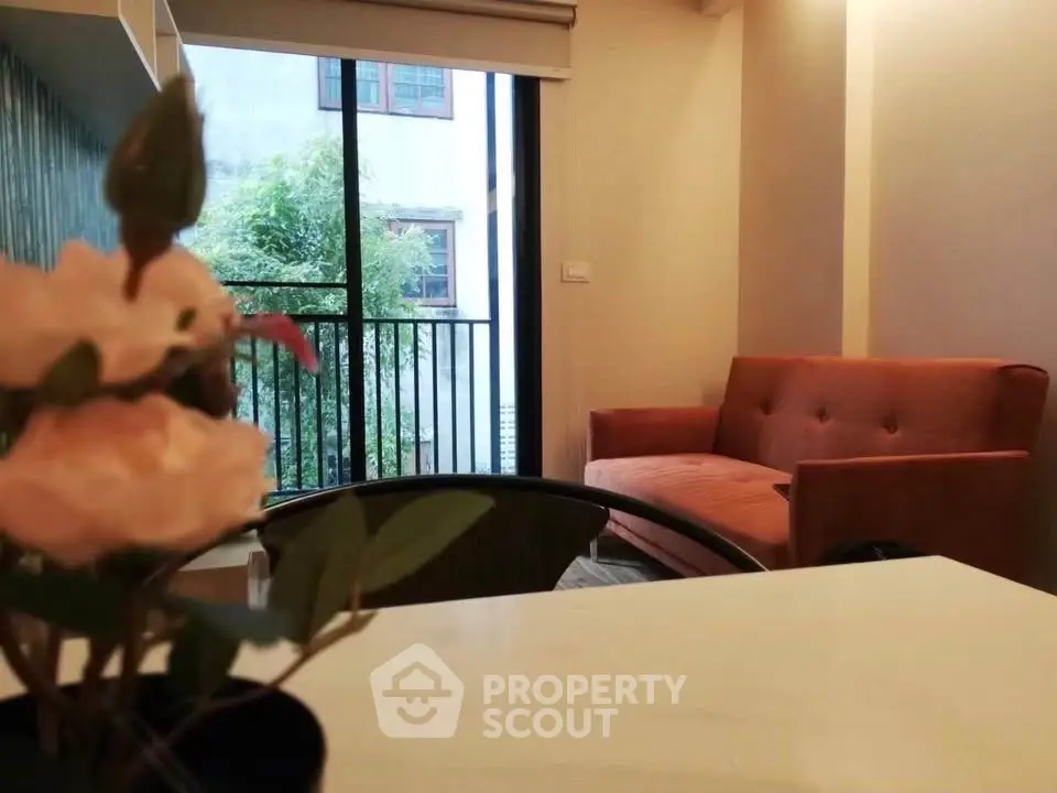 Cozy living room with orange sofa and balcony view