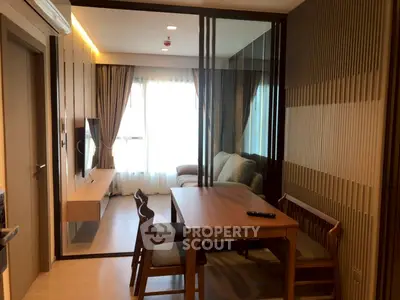 Modern living room with elegant dining area and cozy seating, featuring floor-to-ceiling windows for natural light.