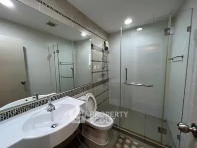 Modern bathroom with glass shower and sleek fixtures
