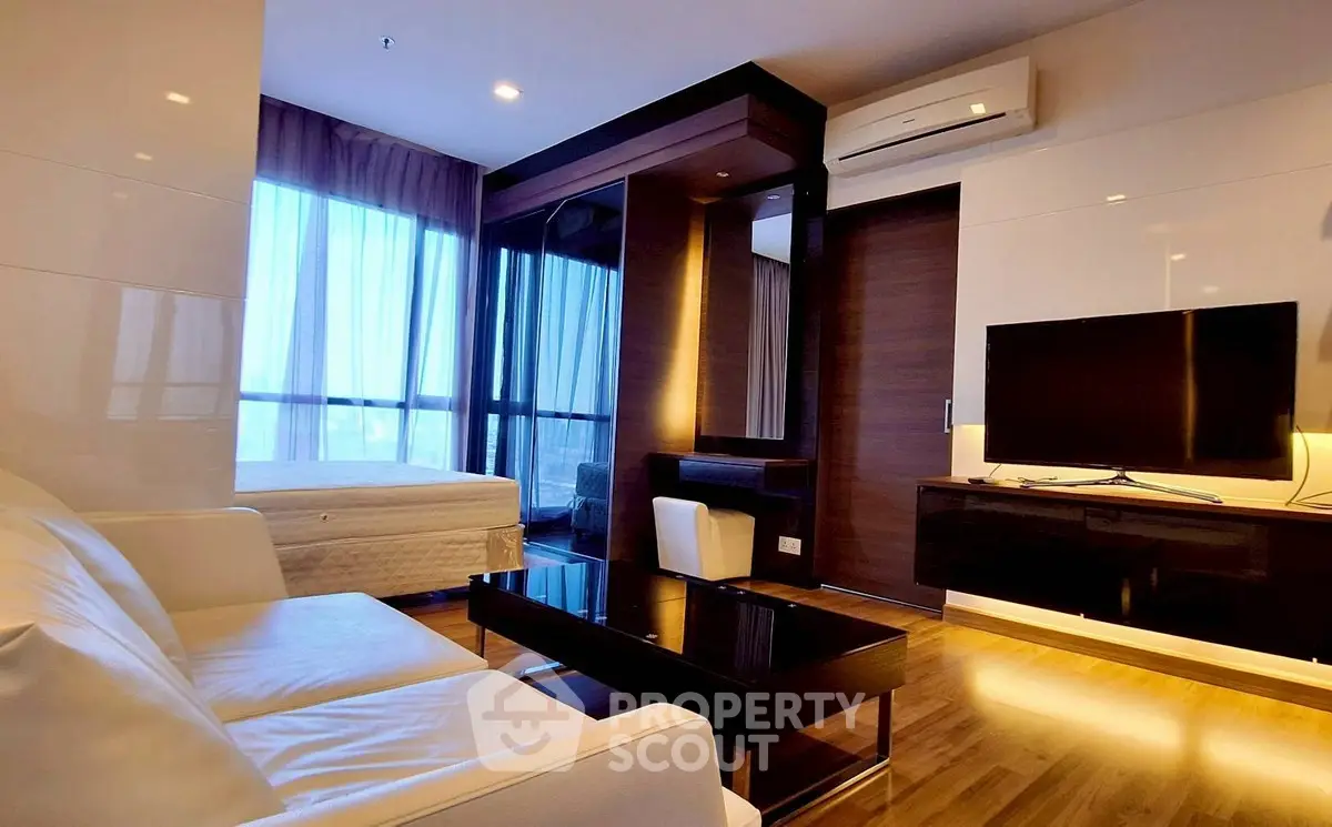 Modern living room with sleek furniture and large windows in a stylish apartment.