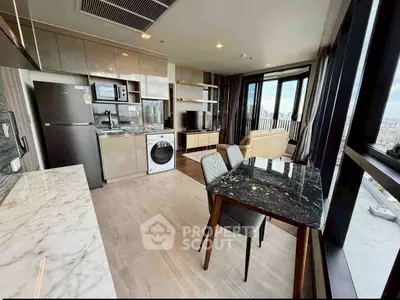 Modern open-plan living room with kitchen, featuring marble countertops and city view.