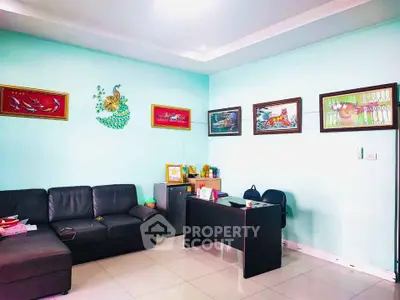 Cozy living room with modern decor and stylish artwork on pastel walls.