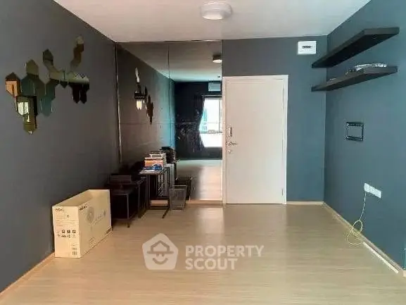 Spacious modern living room with stylish decor and mirrored wall