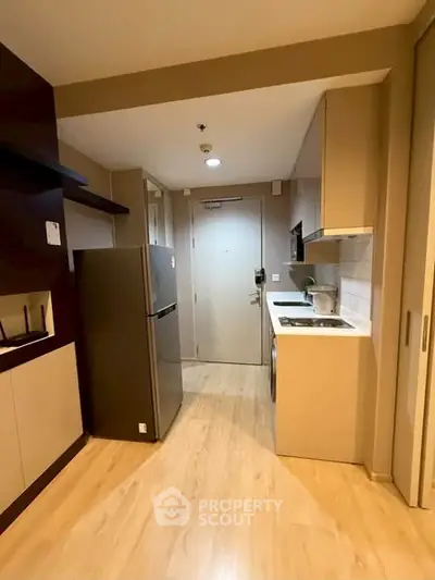 Modern compact kitchen with sleek appliances and stylish cabinetry